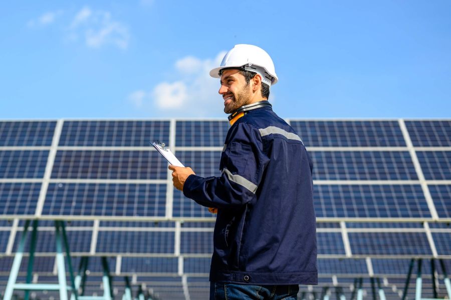 Technician worker installing solar panels at solar cell farm, Engineer working at power station, Electric system maintenance at solar panels field, Eco friendly and clean energy